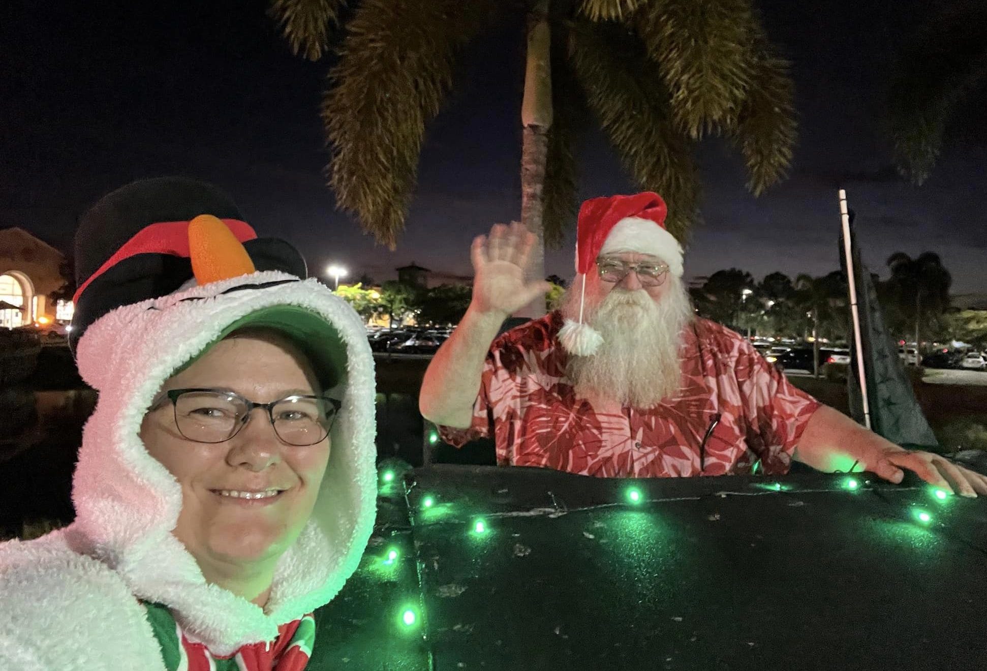 Santa Claus rides along with the Caloosa Jeepers Jeeps at Coconut Point Christmas Parade